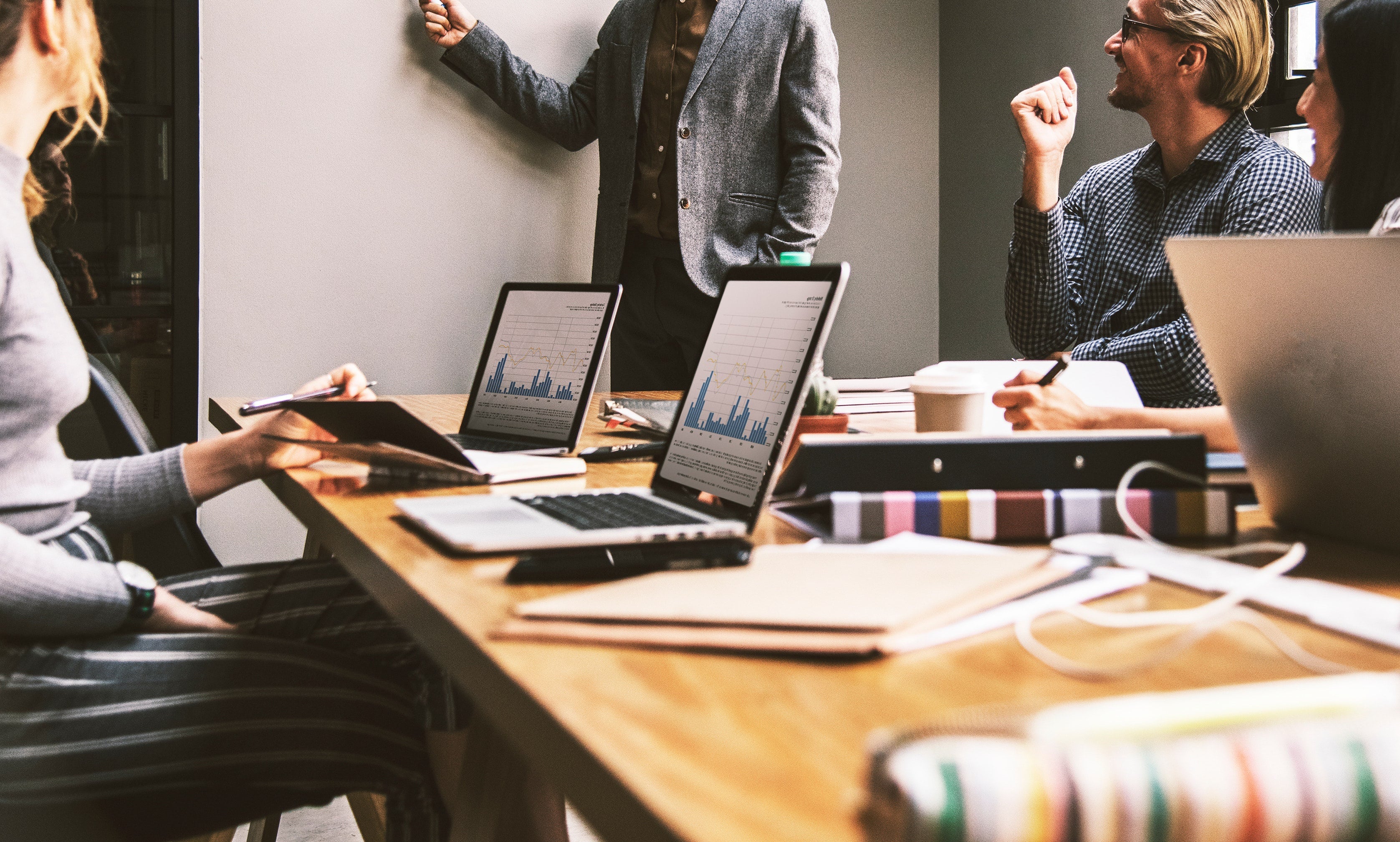 A marketing team reviewing pipeline dashboards together in a meeting room.